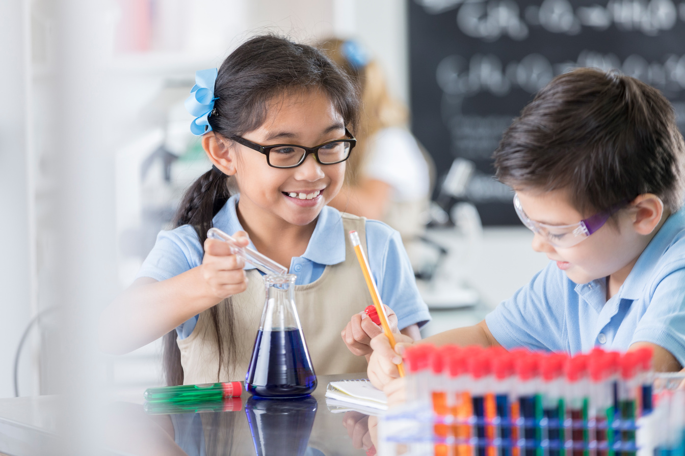 Smiling private school student in science lab